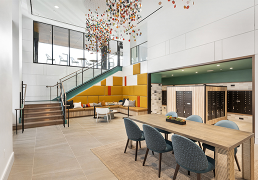 Banner Lane lobby with colorful hanging artwork and white, yellow, and green walls