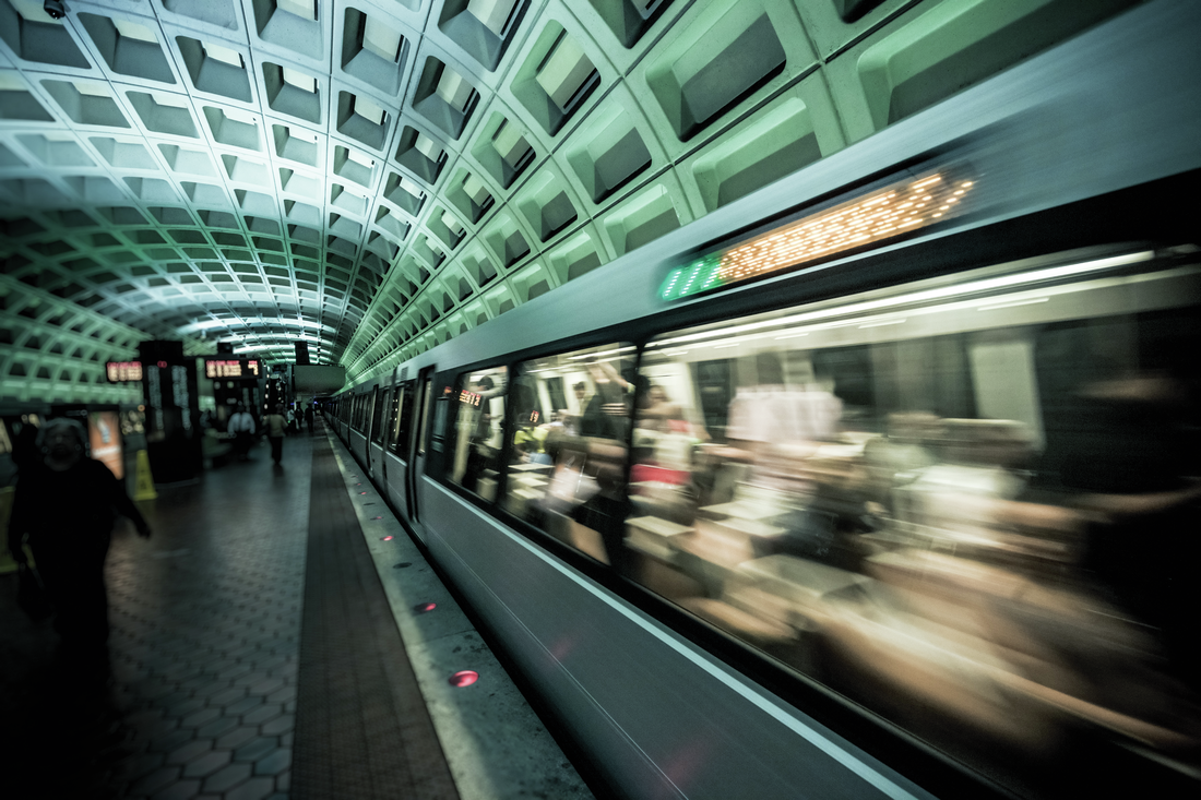 Washington, D.C. subway of a train moving fast past the camera so it's blurred